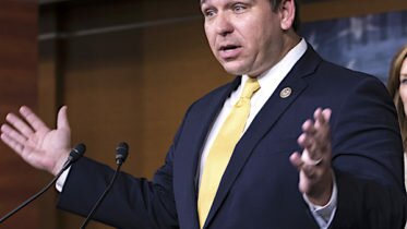 ron desantis exults during a news conference